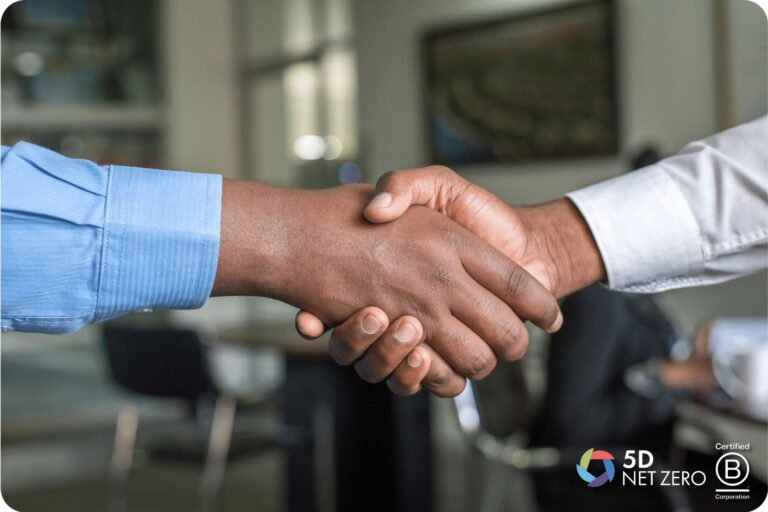 Two people in business attire shake hands in an office setting, highlighting a commitment to net zero goals. The 5D Sustainability and Certified B Corporation logos appear in the bottom right corner of the image.